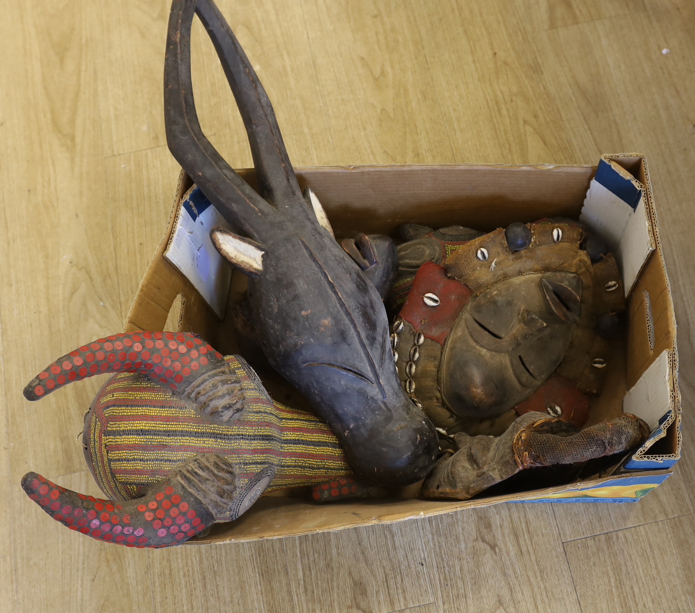 Six African Tribal masks, some decorated with shell and coloured beads, largest 70cm